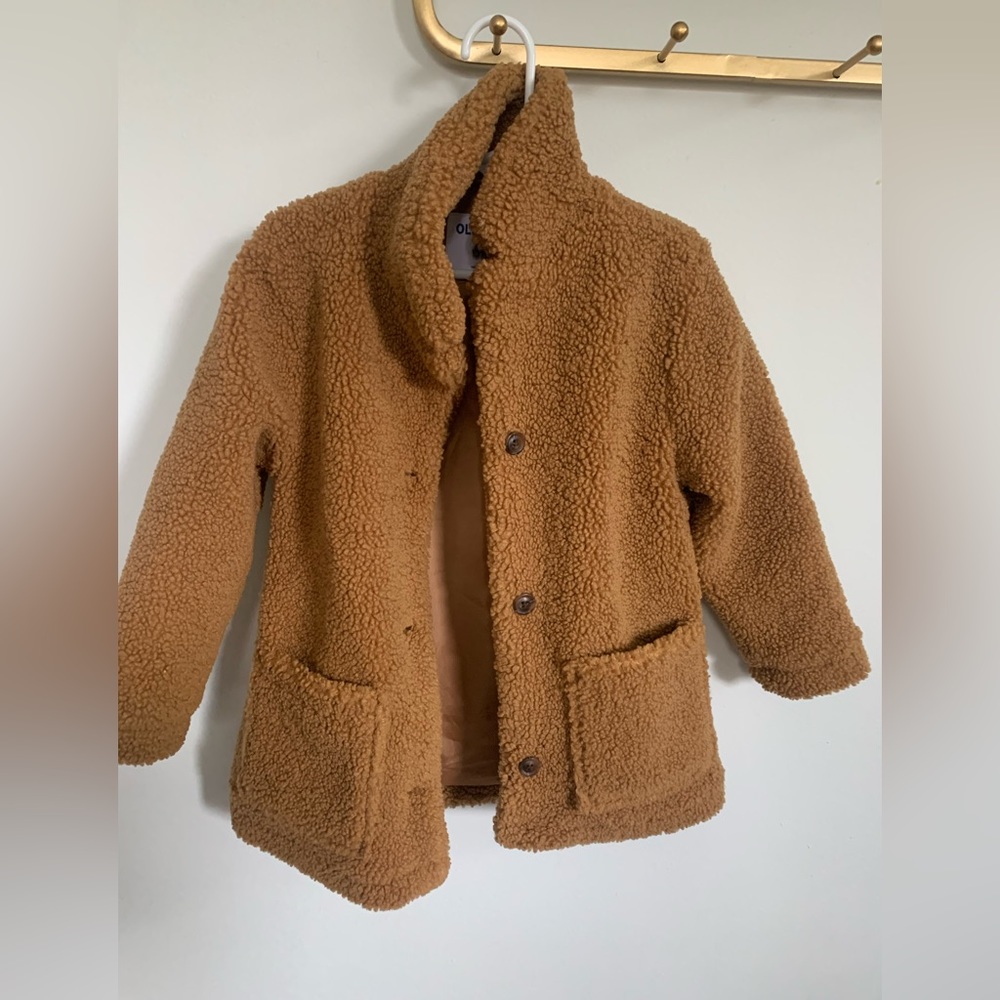 A fuzzy bear jacket that buttons up.
